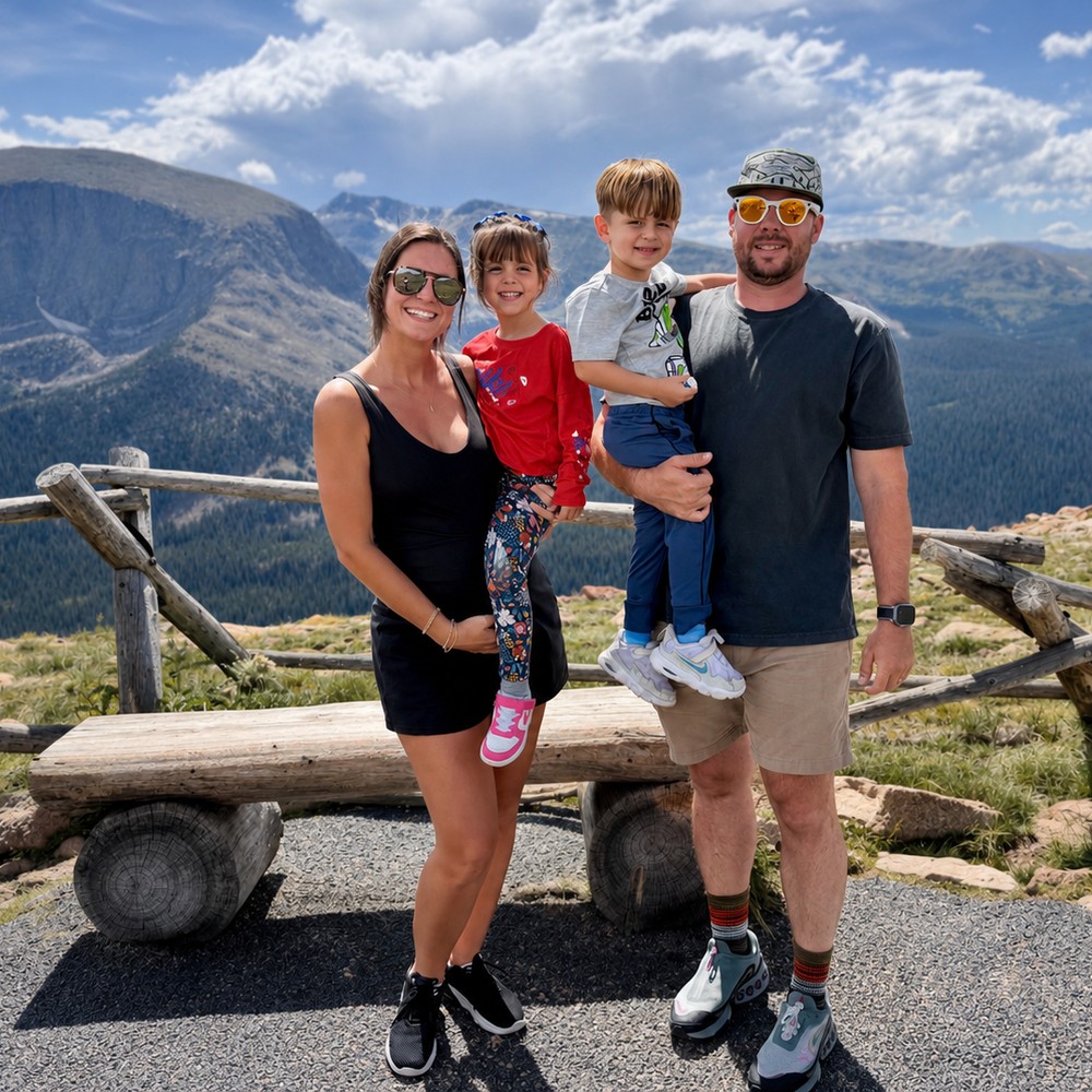 Luiza and family on a mountaintop overlook